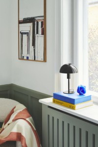Lampa stołowa ELLEN Nordlux 1xE14 40W Metal Czarny na parapecie obok książek.