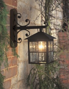 Kinkiet zewnętrzny Elstead Lighting Winchester BL19-BLACK zamontowany na ceglanej ścianie.