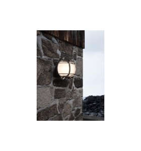 Lampa Ścienna Nordlux E27 12,5W Mosiądz Nikiel zamontowana na kamiennej ścianie.