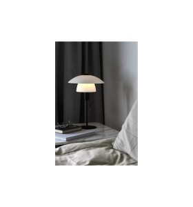 Lampa Stołowa Nordlux E27 15W Czarny na stoliku nocnym przy łóżku.